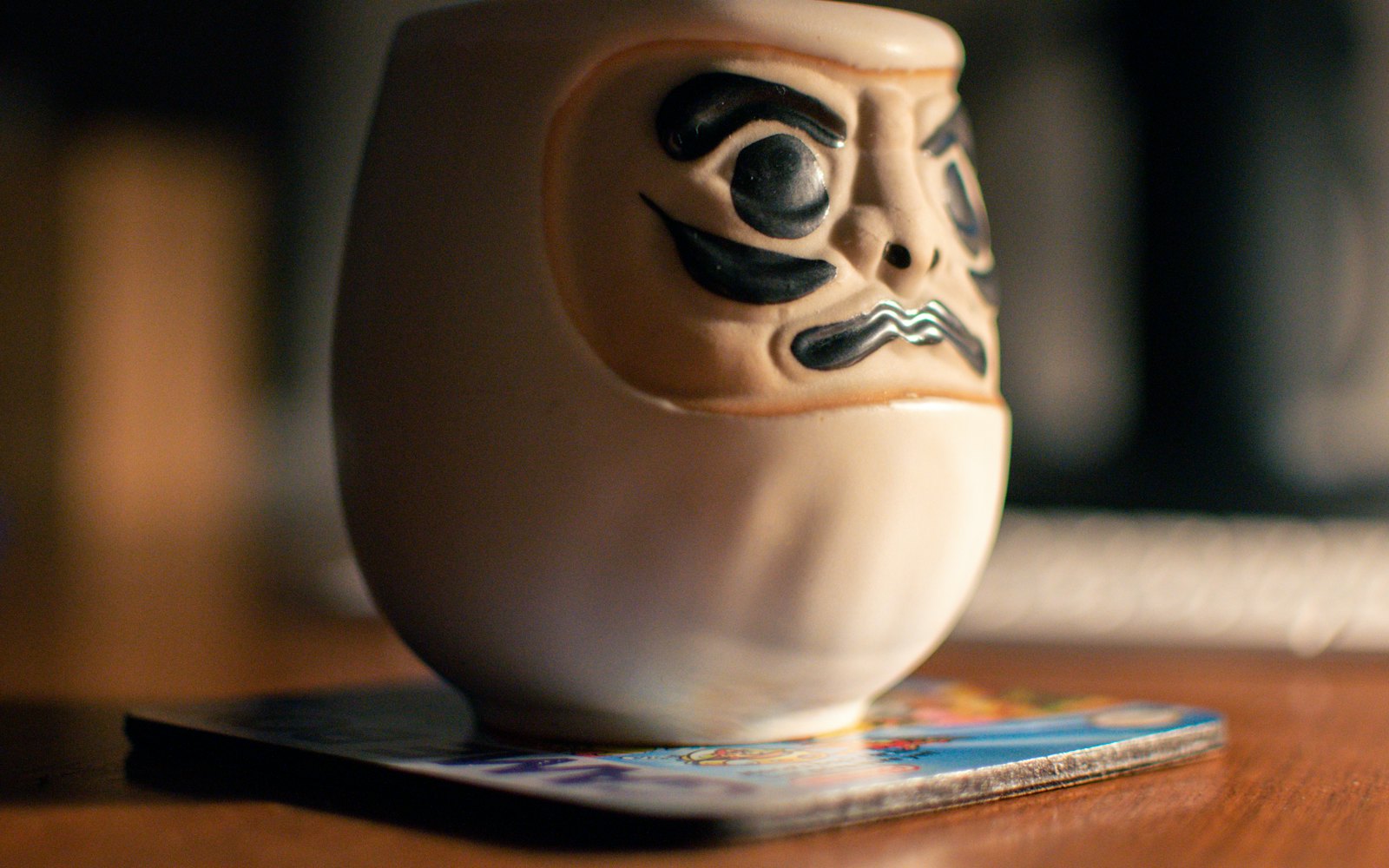 A coffee cup with a face painted on it