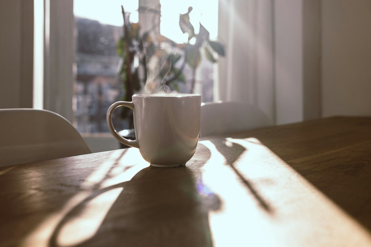 Steaming mug on wooden table