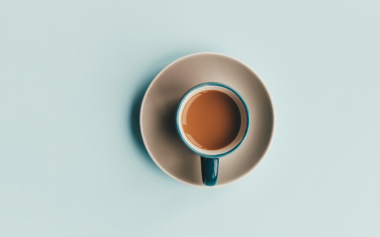 Blue ceramic coffee cup and white saucer