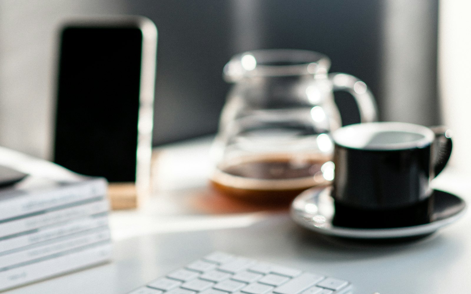 Black ceramic mug on white laptop computer