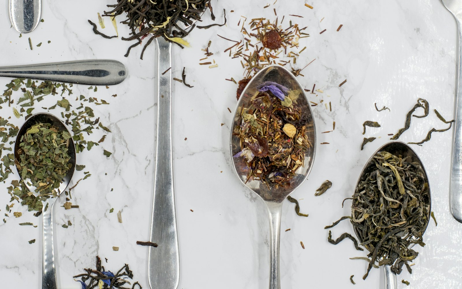 Tea leaves on silver spoons