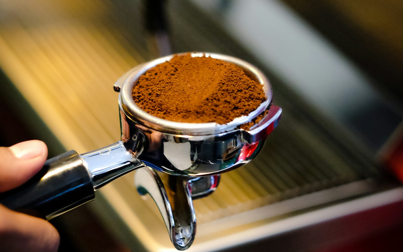 Person holding the espresso portafilter