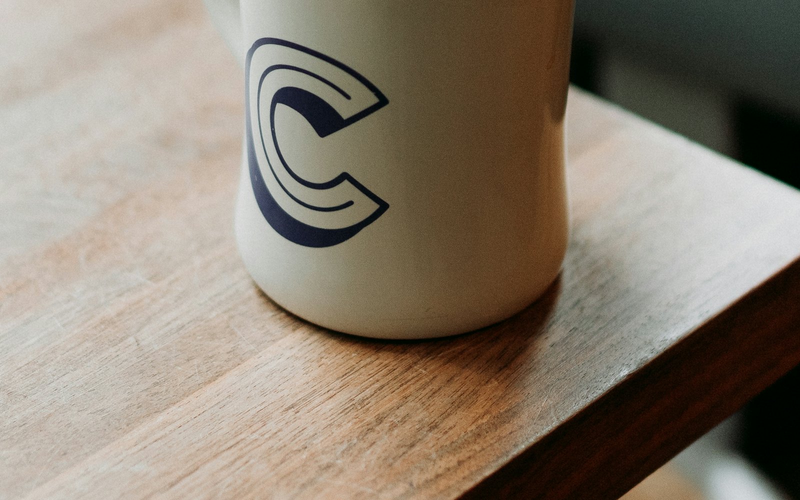 White ceramic mug with black liquid on table