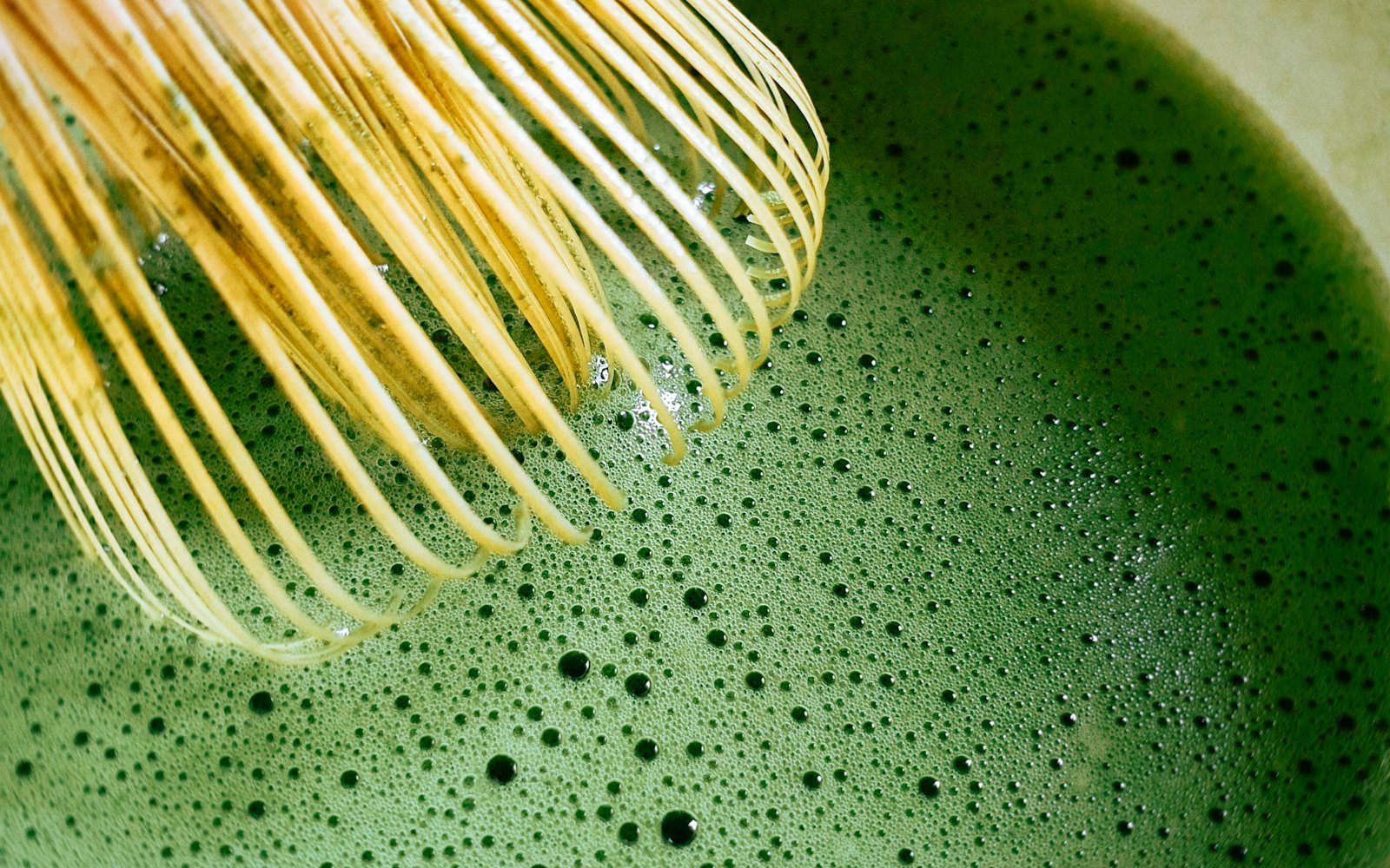 Matcha tea whisking in bowl
