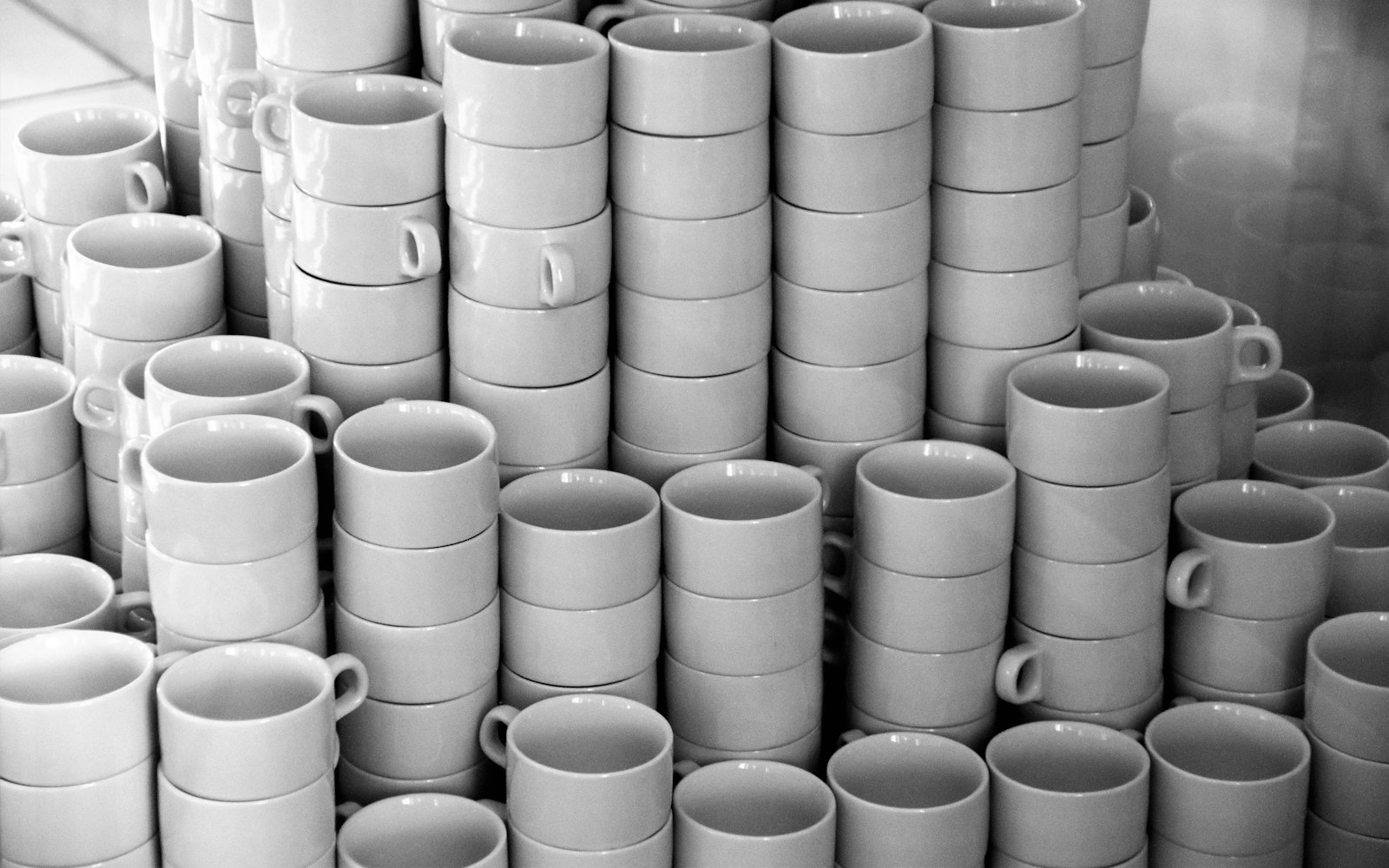 White ceramic mugs on white ceramic plate