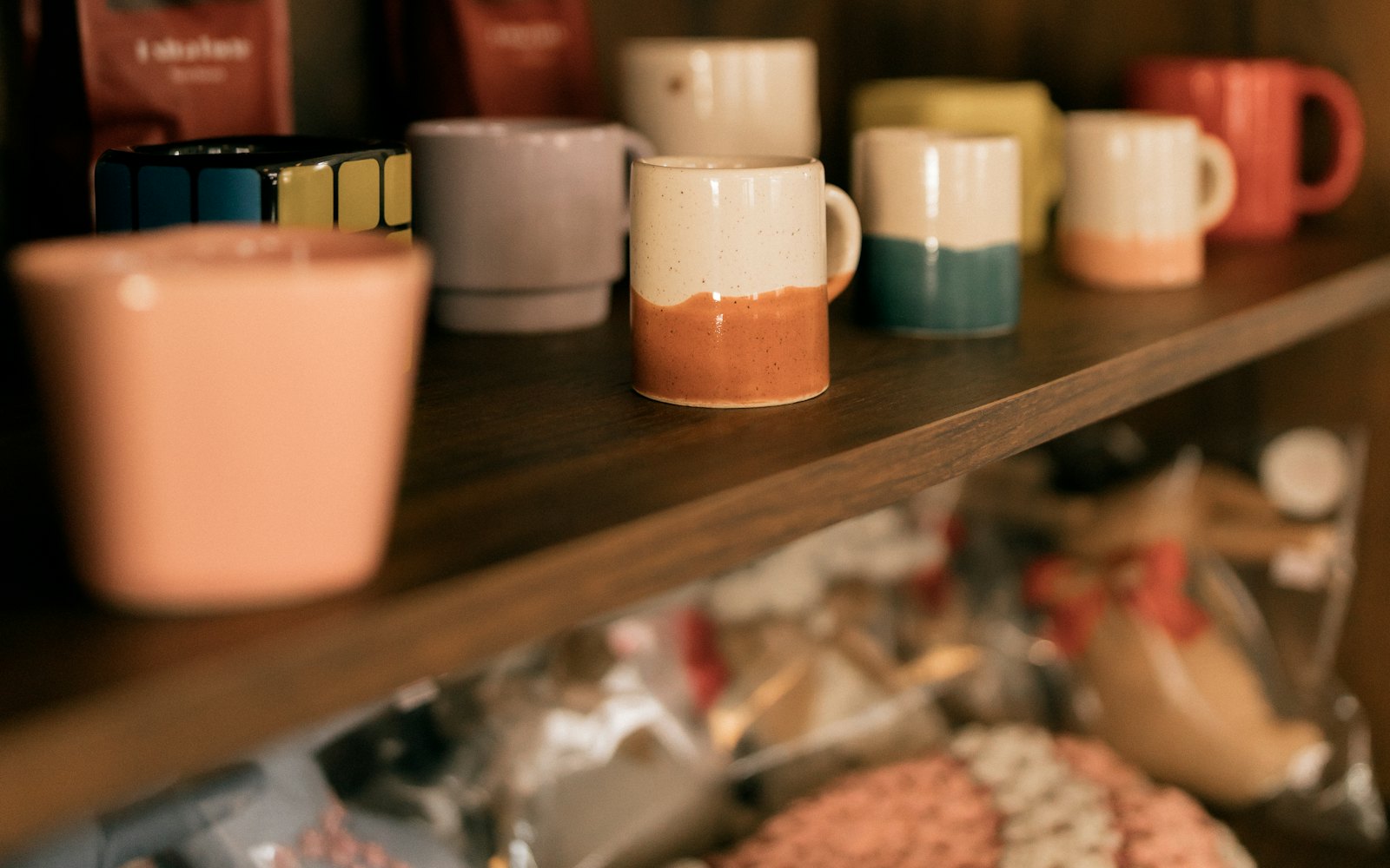 Colorful ceramic mugs and teacups displayed on shelves