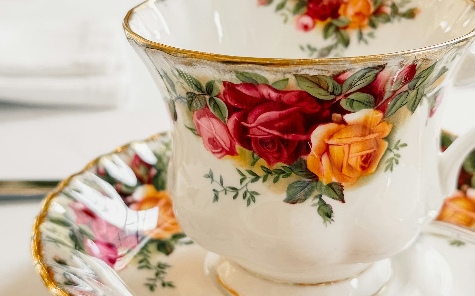 Porcelain teacup with floral rose pattern